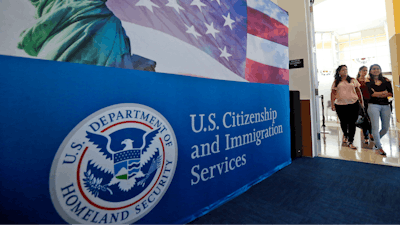 People arrive before the start of a naturalization ceremony at the U.S. Citizenship and Immigration Services Miami Field Office in Miami, Aug. 17, 2018.
