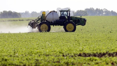 A soybean field is sprayed in Iowa, July 11, 2013. The maker of a popular weedkiller is turning to lawmakers in key states to try to squelch legal claims that it failed to warn about cancer risks.