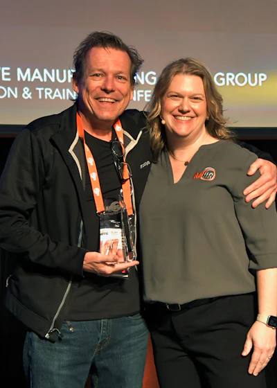 (Left) Mike Littrell of BuildParts by CIDEAS, Inc. receiving the first-place award from Bonnie Meyer for the Advanced Finishing category of AMUG’s 2024 Technical Competition.