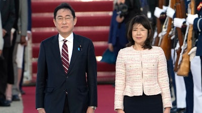 Japan's Prime Minister Fumio Kishida, left, and his wife Yuko Kishida participate in an arrival ceremony at Andrews Air Force Base, Md., Monday, April 8, 2024.