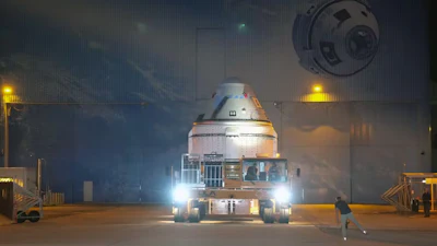 The Starliner capsule in transit.