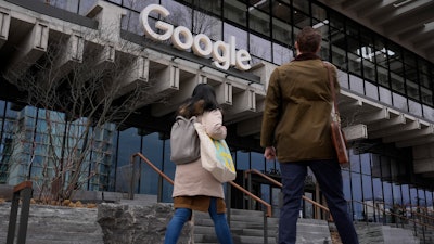 People arrive at the recently opened Google building in New York, Feb. 26, 2024.