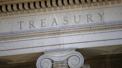 This June 6, 2019, file photo shows the U.S. Treasury Department building at dusk in Washington.