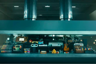 In this image taken from a video advertisement, a hydraulic press crushes an array of creative instruments.