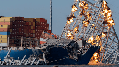 Explosive charges are detonated to bring down sections of the collapsed Francis Scott Key Bridge resting on the container ship Dali on Monday, May 13, 2024, in Baltimore.