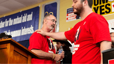 David Johnston, right, a worker at Mercedes, thanks UAW President Shawn Fain following a press conference in Tuscaloosa, Alabama on May 17, 2024, after workers at two Alabama Mercedes-Benz factories voted overwhelmingly against joining the United Auto Workers union.