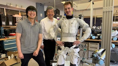 SuperLimbs, a system of wearable robotic limbs built by MIT engineers, is designed to physically support an astronaut and lift them back on their feet after a fall, helping them conserve energy for other essential tasks. Pictured, from left, is Sang-Yoep Lee, Harry Asada, and Erik Ballesteros.