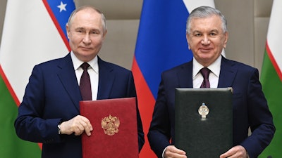 Russian President Vladimir Putin, left, and Uzbek President Shavkat Mirziyoyev attend a signing ceremony following a meeting in expanded format at the Kuksaroy Presidential Palace in Tashkent, Uzbekistan, Monday, May 27, 2024.