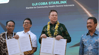Indonesian Minister of Health Budi Gunadi Sadikin, second from left, and Elon Musk, second from right, sign an agreement on enhancing connectivity at a public health center in Denpasar, Bali, Indonesia on Sunday, May 19, 2024.