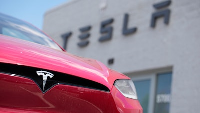 A Model X sports-utility vehicle sits outside a Tesla store in Littleton, Colo., June 18, 2023.