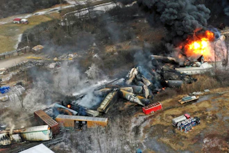Debris from a Norfolk Southern freight train lies scattered and burning along the tracks on Feb. 4, 2023, the day after it derailed in East Palestine, Ohio.