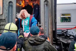 Russian Emergency Ministry workers help a woman to leave a damaged carriage on the Inta - Ugolny stretch to Komi in the northern republic of Komi, Russia.