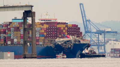 Tugboats escort the cargo ship Dali after it was refloated in Baltimore, Monday, May 20, 2024.
