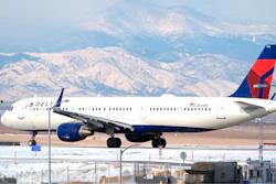 A Delta Airlines jetliner taxis on a runway at Denver International Airport.