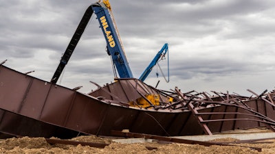 Twisted girders and debris cover the ground the day after a deadly structure collapse at a construction site near the Boise Airport.