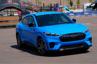 A motorist puts an electric 2024 Ford Mustang Mach-E through its paces on a test track at the Electrify Expo in The Yards Sunday, July 14, 2024, in north Denver.