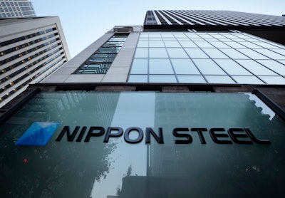 Nippon Steel Corporation's logo is displayed on a sign outside its headquarters in Tokyo on Nov. 26, 2021.