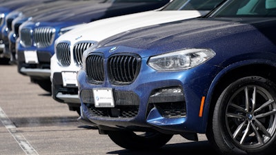 A long row of unsold 2021 X3 sports-utility vehicles sits at a BMW dealership.