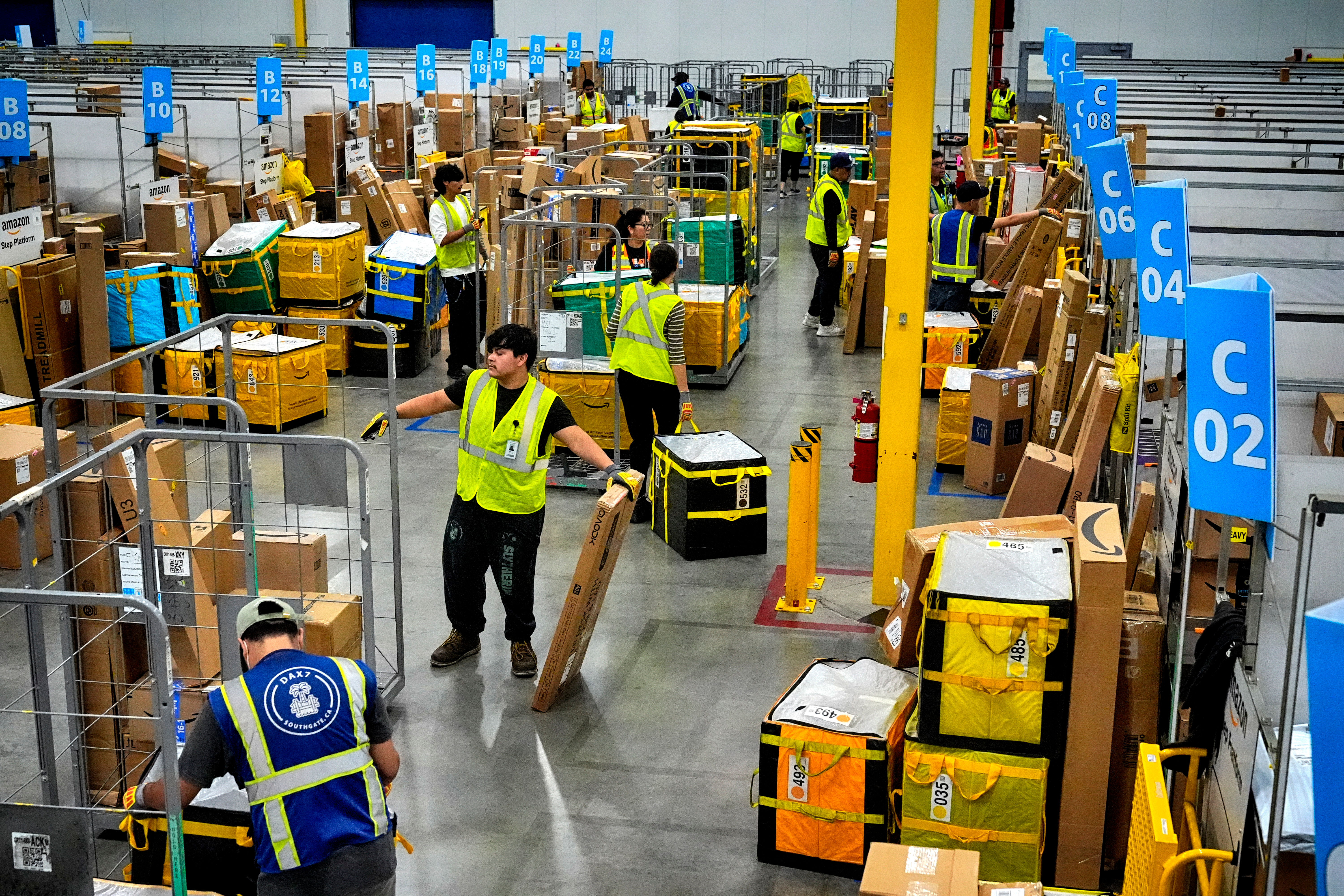 Amazon employees load packages at Amazon's DAX7 delivery station, South Gate, Calif., July 16, 2024.
