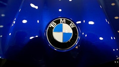 The company logo shines on the hood of an unsold vehicle at a Mini Honda BMW dealership.