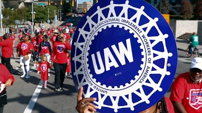 United Auto Workers members walk in the Labor Day parade in Detroit, Sept. 2, 2019.