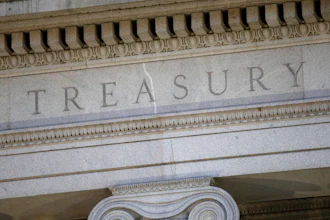 This June 6, 2019, file photo shows the U.S. Treasury Department building at dusk in Washington.