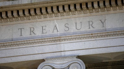 This June 6, 2019, file photo shows the U.S. Treasury Department building at dusk in Washington.