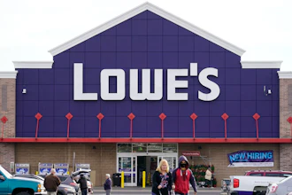 Shoppers walk in the lot of a Lowe's home improvement store in Philadelphia, Wednesday, Nov. 17, 2021.