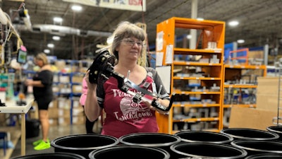 An employee at PLP's Rogers, Arkansas manufacturing facility assembles COYOTE Dome Closures for shipment.