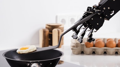 A robot frying an egg.