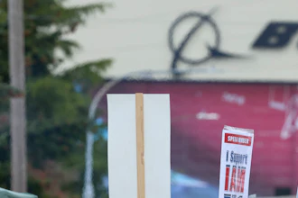 Boeing Machinists Union member Stephanie Corona waves to passing traffic while on the picket line at the Everett plant, Friday, Sept. 13, 2024, in Everett, Wash.