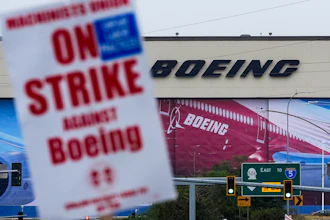 Boeing workers wave picket signs as they strike after union members voted to reject a contract offer, Sunday, Sept. 15, 2024, near the company's factory in Everett, Wash.