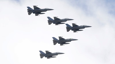 Taiwan's F-16 fighter jets fly in close formation over President Office during National Day celebrations in front of the Presidential Building in Taipei, Taiwan, Oct. 10, 2021.