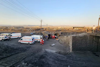 In this photo released by Iranian Red Crescent Society, ambulances stand at the site of a coal mine where methane leak sparked an explosion on Saturday, in Tabas, some 335 miles (540 kilometers) southeast of the capital Tehran, Iran, Sunday, Sept. 22, 2024.