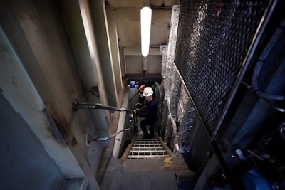 Abigail Jablansky, head of project management, walks down the stairs on the NH3 Kraken, a tugboat powered by ammonia, Friday, Sept. 13, 2024, in Kingston, N.Y.