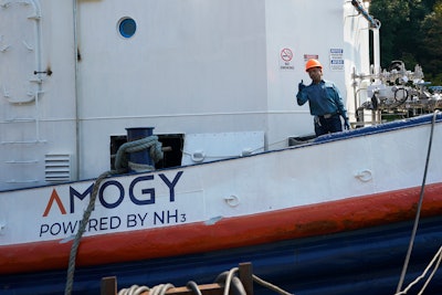 Worker gestures from the NH3 Kraken, a tugboat powered by ammonia, Friday, Sept. 13, 2024, in Kingston, N.Y.