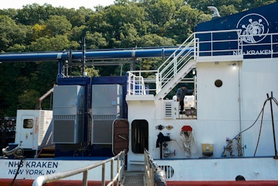 A worker walks on the NH3 Kraken, a tugboat powered by ammonia, Friday, Sept. 13, 2024, in Kingston, N.Y.