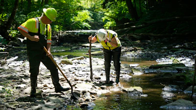 Environmental Protection Agency workers work in Leslie Run in East Palestine, Ohio, June 12, 2024.