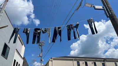 Pairs of jeans flap over Jeans Street in Kojima, Okayama prefecture, Japan, on Sept. 4, 2024.