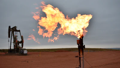 A flare burns natural gas at an oil well in Watford City, N.D.