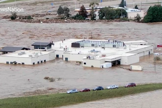 In this image made from a video provided by NewsNation, people can be seen on the roof of the Unicoi County Hospital in Erwin, Tenn., on Friday, Sept. 27, 2024.