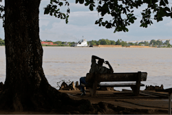 A man sits on the banks of the Suriname River in Paramaribo, Suriname, Aug. 10, 2010.