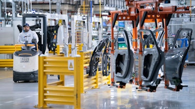 A worker operates a machine at the BMW Spartanburg plant in Greer, S.C., Oct. 19, 2022.