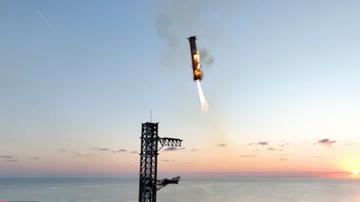 This image provided by SpaceX shows SpaceX's mega rocket booster returning to the launch pad to be captured during a test flight Sunday, Oct. 13, 2024, in Boca Chica, Texas.