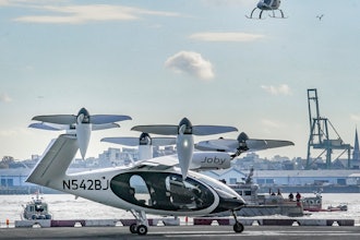 An electric vertical takeoff and landing (eVTOL) aircraft, flies above the Joby eVTOL aircraft, during a demonstration of eVTOLs Nov. 13, 2023, in New York.