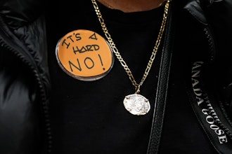 Boeing employee Gina Forbush wears an pin saying 'IT'S A HARD NO!' while listening to the announcement that union members voted to reject a new contract offer from the company, Wednesday, Oct. 23, 2024, at Seattle Union Hall in Seattle.
