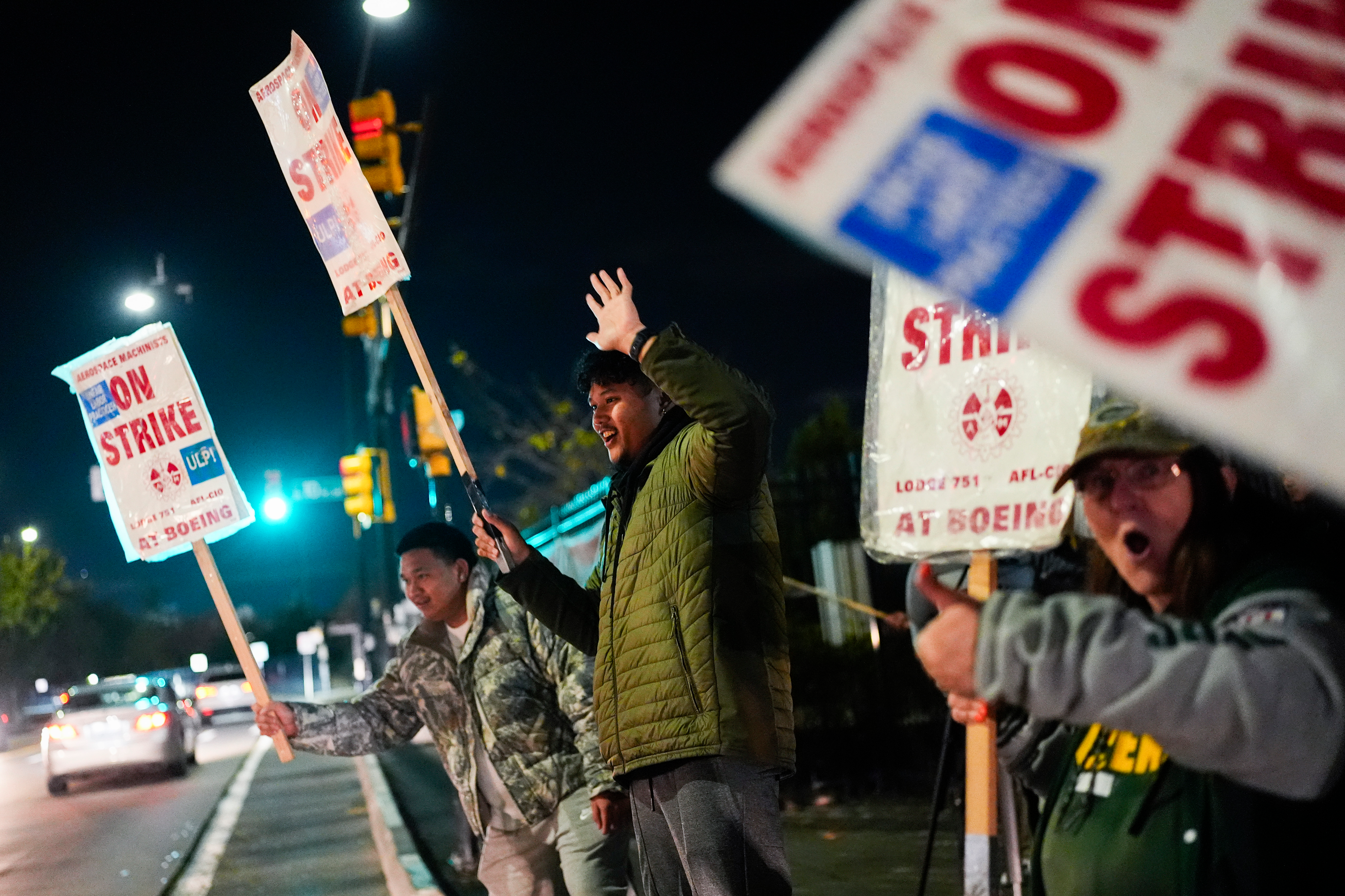 Boeing employees, including assembler Tyrone Hipolito, center, work the picket line after union members voted to reject a new contract offer from the company, Wednesday, Oct. 23, 2024, in Renton, Wash.