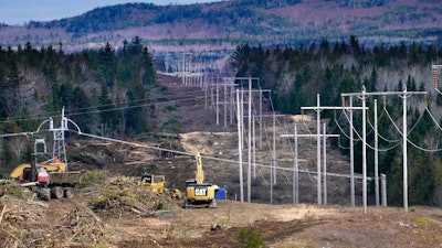 Heavy machinery is used to cut trees to widen an existing Central Maine Power power line corridor to make way for new utility poles, April 26, 2021, near Bingham, Maine.