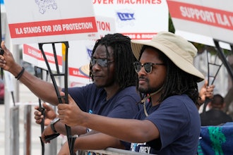 Dockworkers from Port Miami display signs at a picket line, Oct. 3, 2024.