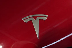 The logo of Tesla car is pictured at the Paris Auto Show, in Paris, Monday, Oct. 14, 2024.